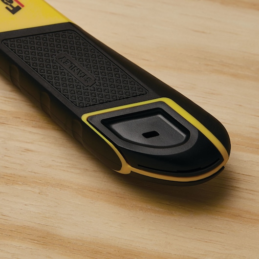 Photo of STANLEY 10-486 utility knife handle, black and yellow with textured grip, close-up on wood surface.