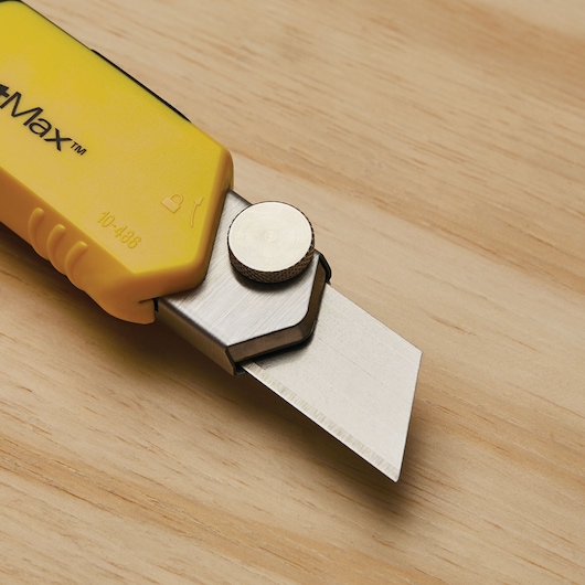 Photo of STANLEY 10-486 utility knife with yellow handle and exposed blade on wood surface.