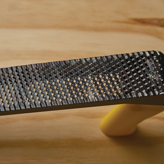 STANLEY 21-296 hand rasp with black metal blade and yellow handle, close-up side angle.
