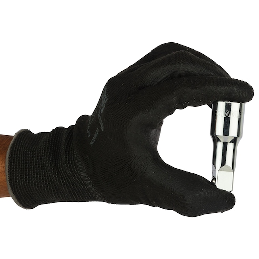 Photo of STANLEY 4-86-406 hex bit socket, held by a gloved hand, tool facing right, white background.
