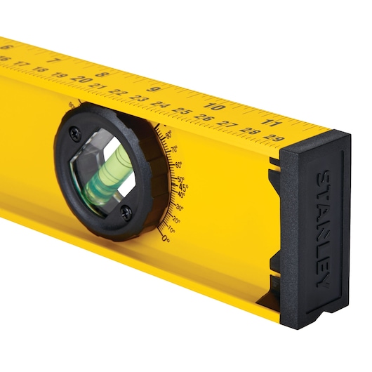 STANLEY 42-324 yellow spirit level with black end cap, angle gauge, and ruler, front angled view.