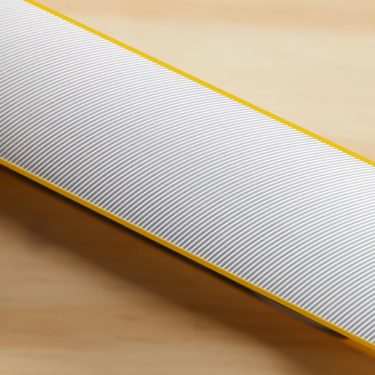 STANLEY 43-524 photography of a close-up of yellow-edged measuring tool with fine white and gray lines.