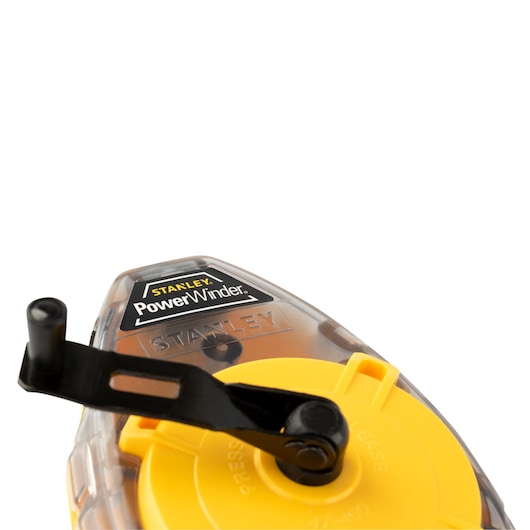 STANLEY 47-460 chalk line reel, close-up of transparent case, yellow reel, and black winding handle.