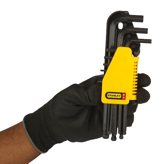 STANLEY hex key set held in gloved hand. SKUs: 69-256-KR, 69-256. Photography category.
