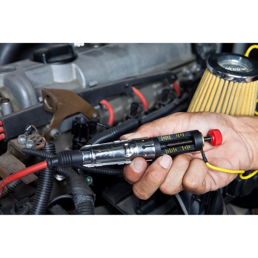 Photography of a STANLEY Spark Plug Cable Tester in use