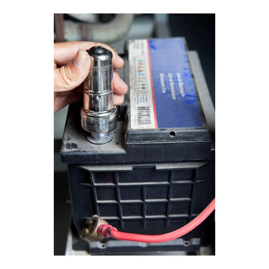 Photo of STANLEY 79-047 socket wrench being used on a car battery terminal, close-up view.