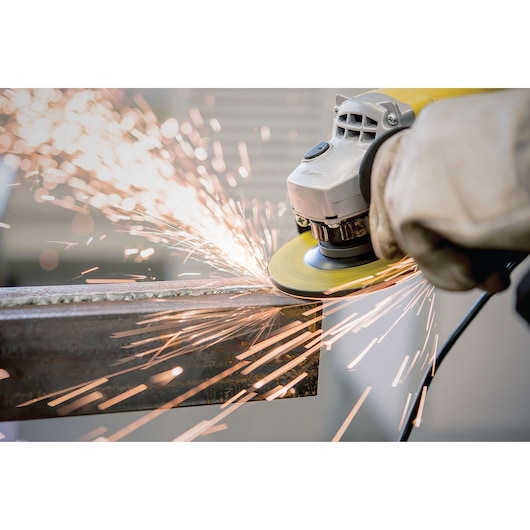 STANLEY STA0413 angle grinder in use, close-up with sparks flying while grinding metal.
