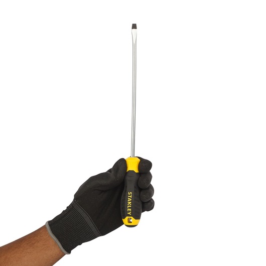 Photo of STANLEY STMT60829-8 flathead screwdriver with yellow and black handle held upright by gloved hand.