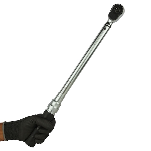 STANLEY STMT73590 torque wrench held by gloved hand, silver finish, photography, side angle.