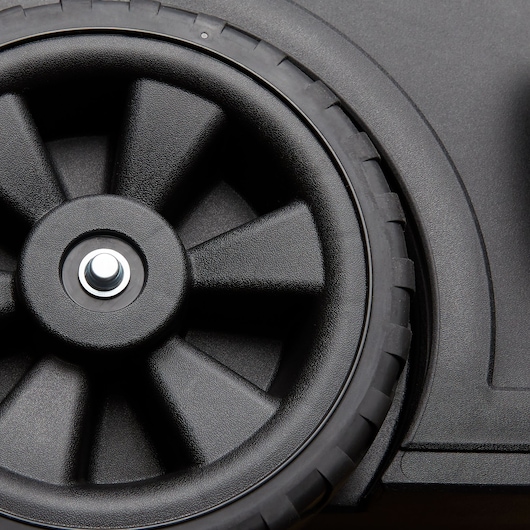 Photo of STANLEY STST18613 black plastic wheel with textured spokes on a toolbox.