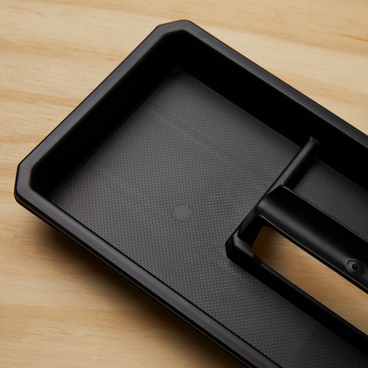 STANLEY STST18613 black plastic tool tray, angled view on wood background.